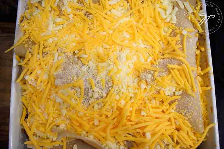 A final sprinkle of cheese blend on top of the finished homemade lasagna.