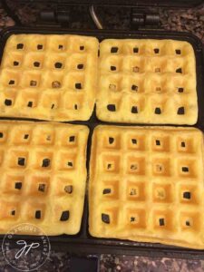 Golden egg waffles sitting in the waffle maker, just made and ready to serve.