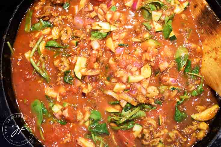 The sauce cooking in a skillet.