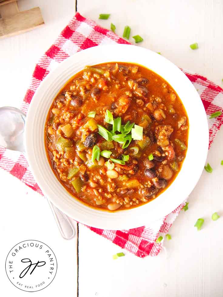 An overhead view of a bowl of beef chili.