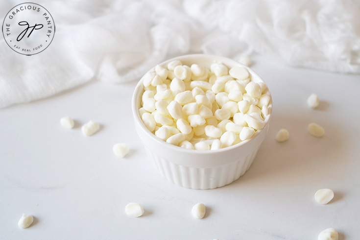 A small white bowl sits on a white surface filled with homemade Dippin Dots Ice Cream.