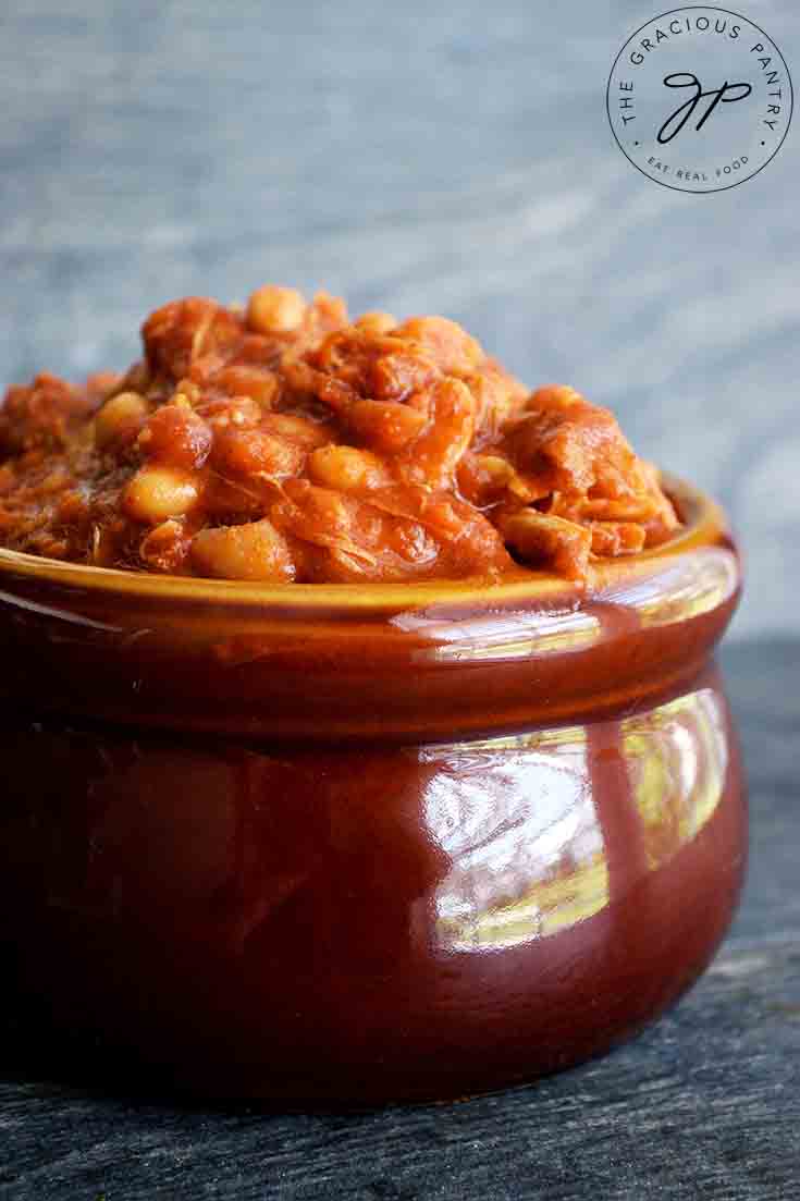 A side view of a brown crock, overfilled with this Instant Pot Chicken Chili Recipe.