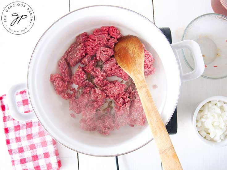 Raw, ground beef in a pot.