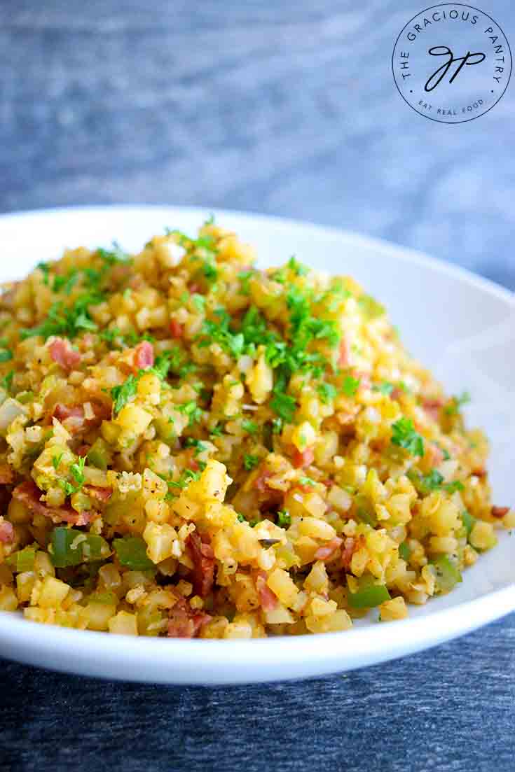 A side view of this Dirty Cauliflower Rice Recipe in a white serving bowl.