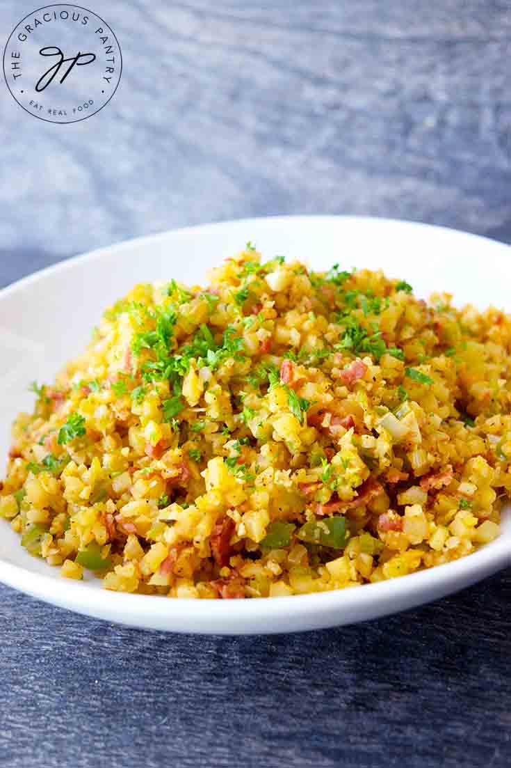 An angled shot of this Dirty Cauliflower Rice Recipe sprinkled with fresh parsley.