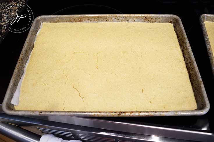 The sheet pan pancakes are done baking when the top looks cooked, there are small cracks in the top and the color is slightly darker than it was.