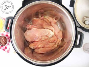 Place your chicken in your pressure cooker.