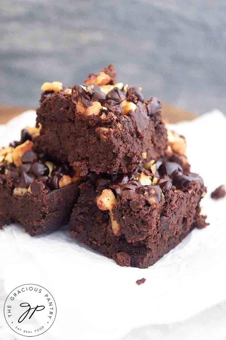 Three Black Bean Brownies stacked on some parchment paper.