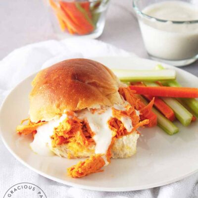 Buffalo Chicken Sandwiches prepared and on a plate with a side of cut veggies