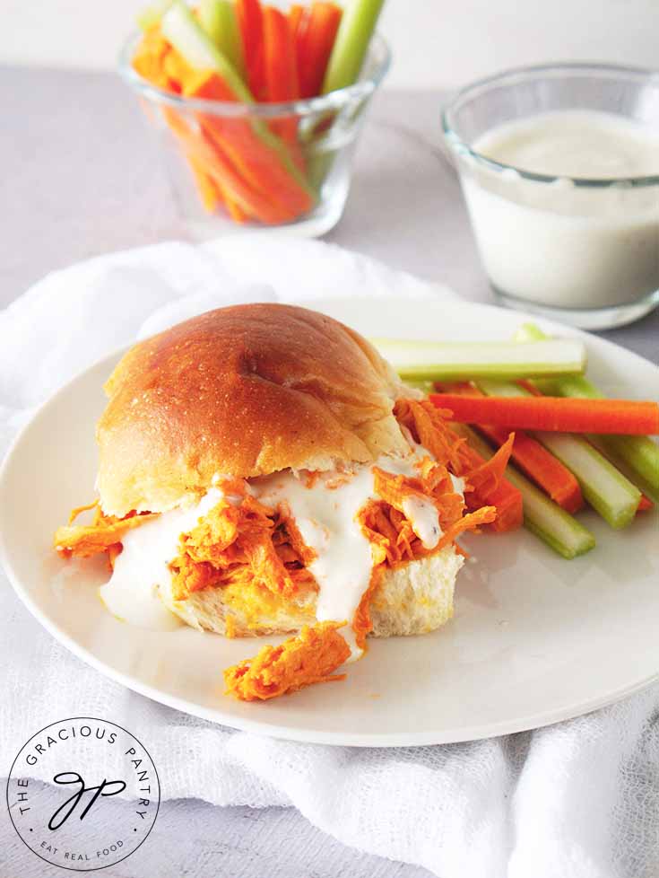 Buffalo Chicken Sandwiches prepared and on a plate with a side of cut veggies