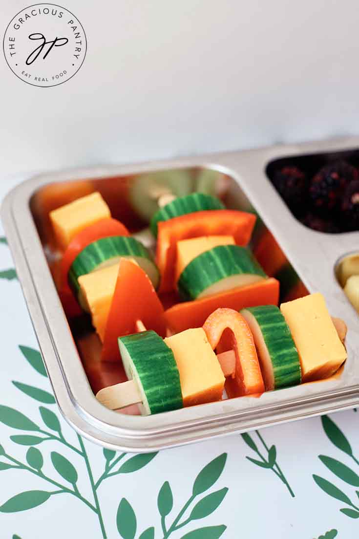 A bento-style lunchbox with Cheese Kabobs in the main compartment.