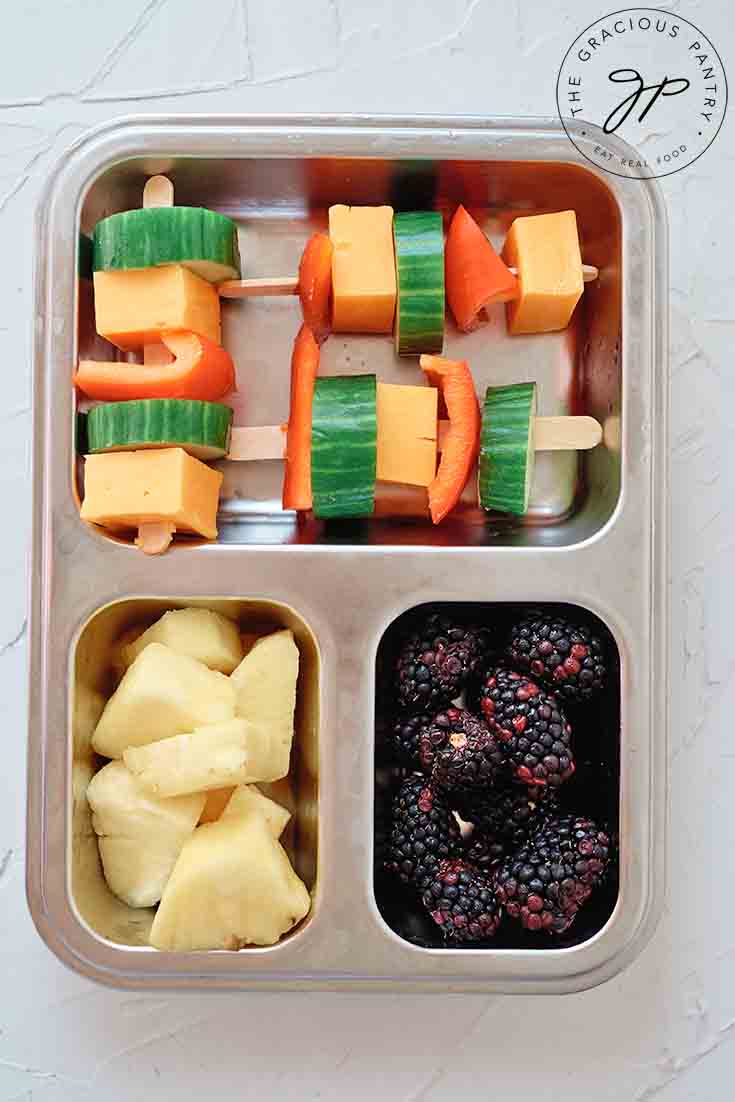 And overhead view of Cheese Kabobs in a bento-style lunchbox.