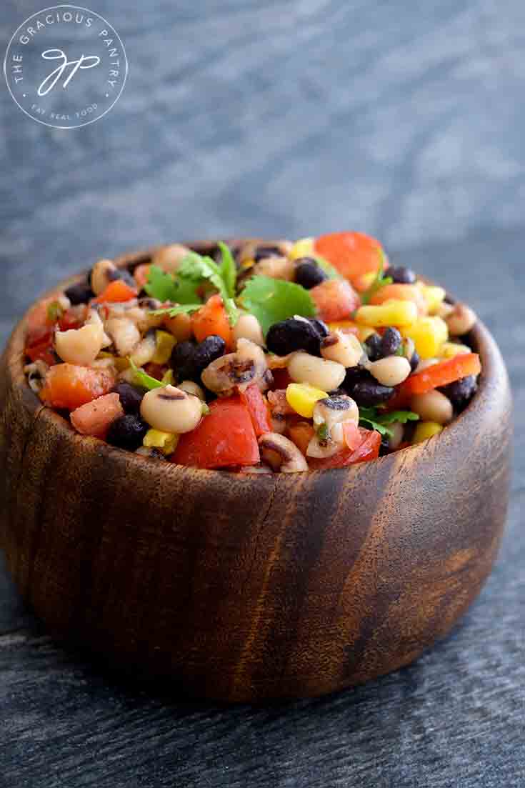 A bowl of this Cowboy Caviar Recipe in a wooden bowl.