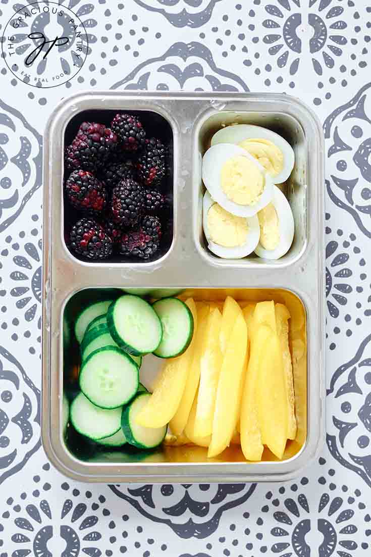 A bento style lunchbox filled with healthy lunchbox snacks.