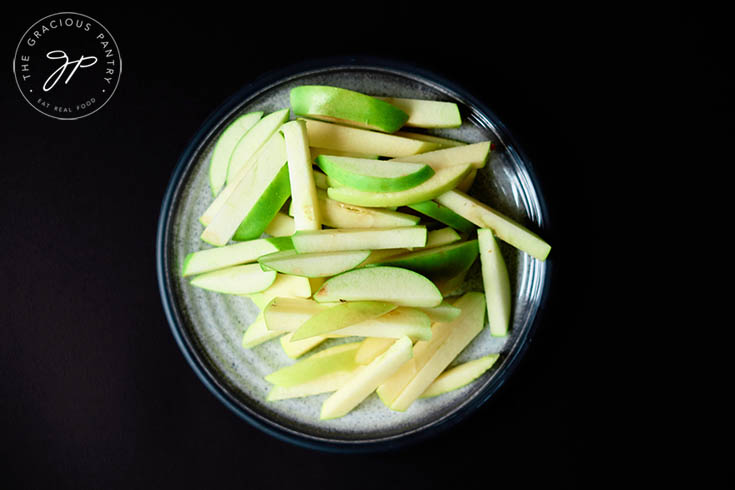 Cut apple fries, raw, on a plate. Ready to be prepped for the air fryer.