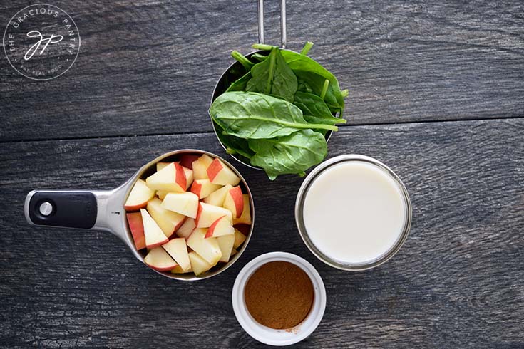 Ingredients for this cinnamon apple smoothie recipe sitting in individual measuring cups.