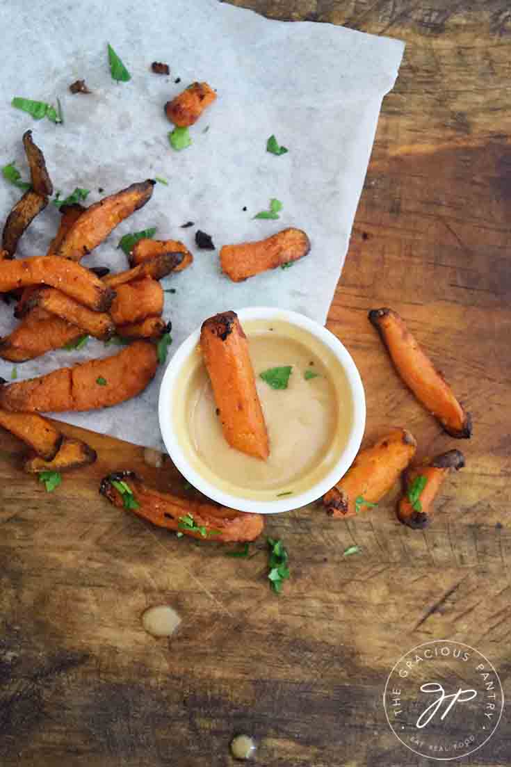 An overhead view of this sauce ce in a dish with sweet potato fries scattered around the dipping dish.