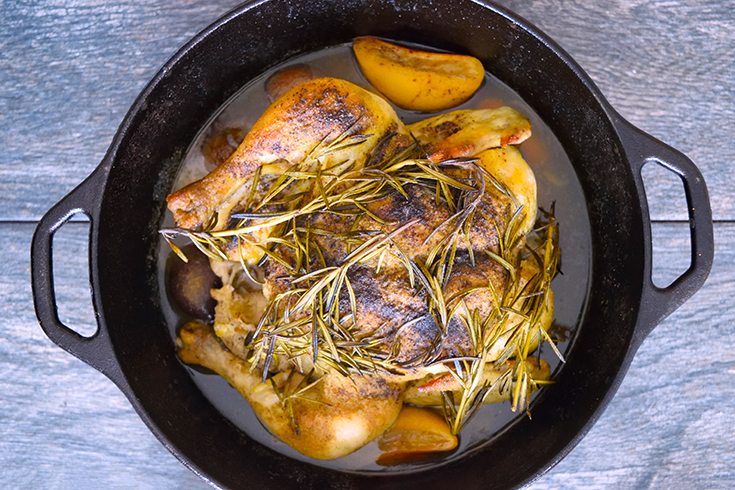 Horizontal overhead view of cooked dutch oven chicken.