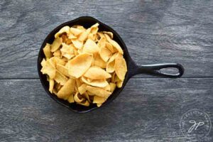 Chips in a skillet waiting for some Nacho Cheese Sauce.