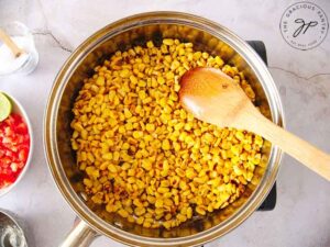 Cook the corn in the oil until it begins to brown a bit.