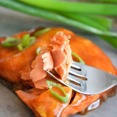A Teriyaki Salmon Fillet with a fork holding a single bite.