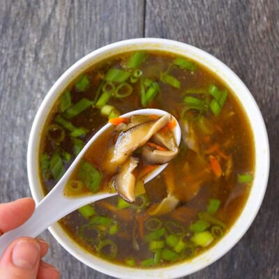 And overhead shot looking down into a white bowl filled with this Asian Mushroom Soup.