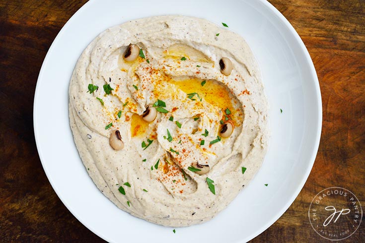 Horizontal overhead view looking down into a bowl filled with Black Eyed Pea Hummus.
