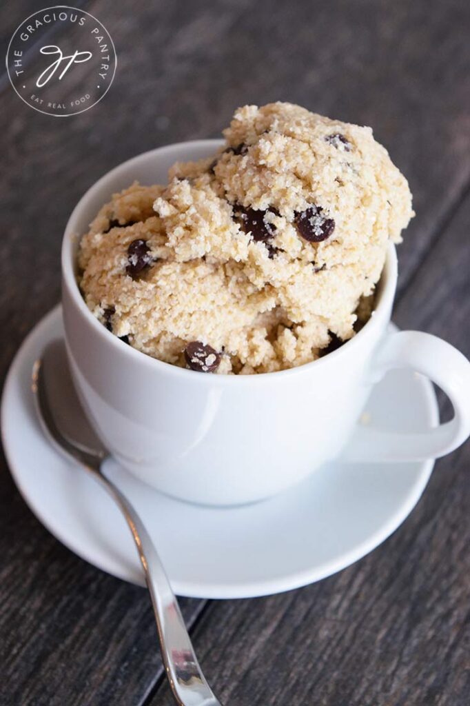 Scoops of this Edible Cookie Dough in a tea cup with a saucer and small spoon.