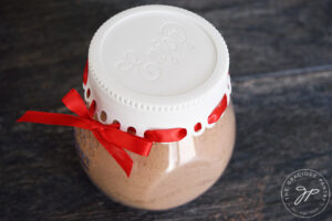 A side view of the finished mug cake mix in a festive storage container.