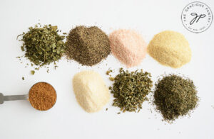 The individual spices in this Ranch Dressing Mix Recipe, in little piles on a white background.