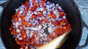 Sautéing the onions and bell peppers.