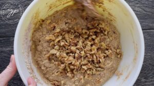 Stirring nuts into the batter.