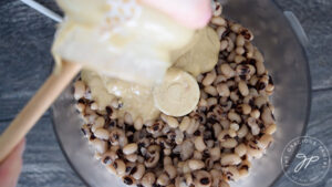 Adding tahini to food processor.