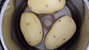 Three large potatoes in the Instant Pot with water and salt.