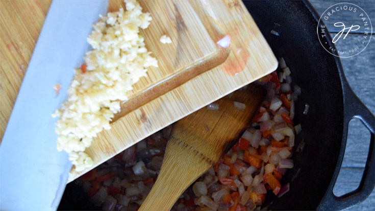 Adding the garlic to the pot.