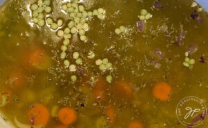 All split pea soup ingredients in pot, ready to cook.