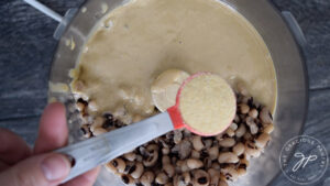 Adding garlic powder and lemon juice to food processor.