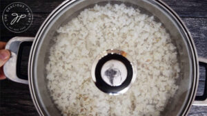 The lid on the pot so the popcorn can popl