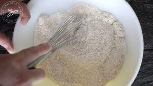 Whisking dry ingredients together.