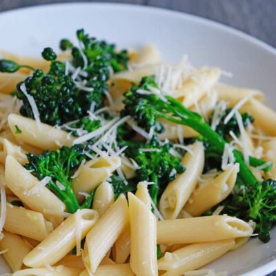 Garnished Garlicky Broccolini Pasta served at the table in a white bowl.