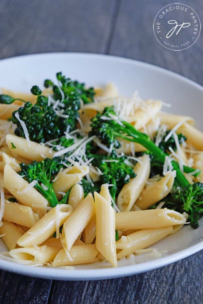 Garnished Garlicky Broccolini Pasta served at the table in a white bowl.