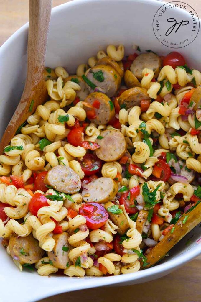 Side view of a large white mixing bowl filled with this cavataoppi pasta recipe.