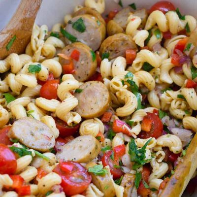 Up close shot of the finished cavatappi pasta in a white bowl.