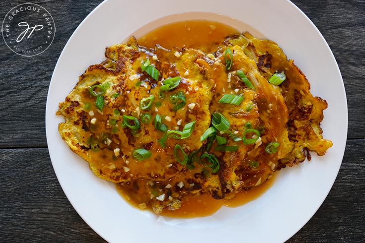 An overhead, horizontal shot looking down onto a plate of egg foo young.