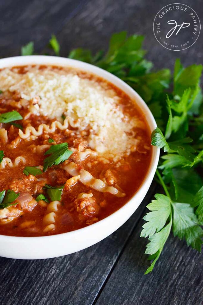 Side view of a white bowl filled with this Lasagna Soup Recipe.