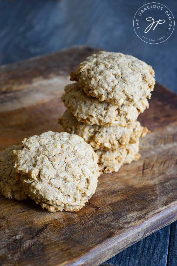 Oatmeal Cookies stacked up on a cutting board.