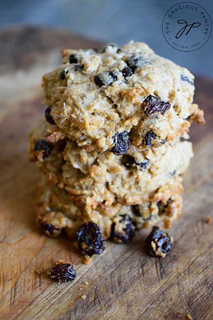 Oatmeal Raisin Cookies stacked up on a cutting board.