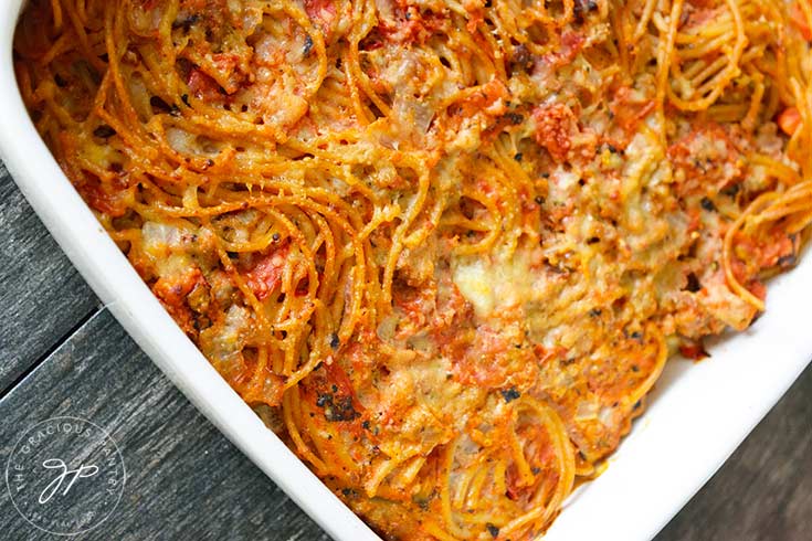 The finished, baked spaghetti pie, still uncut and in the casserole dish.