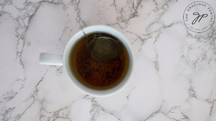 Steeping the tea in a white mug.