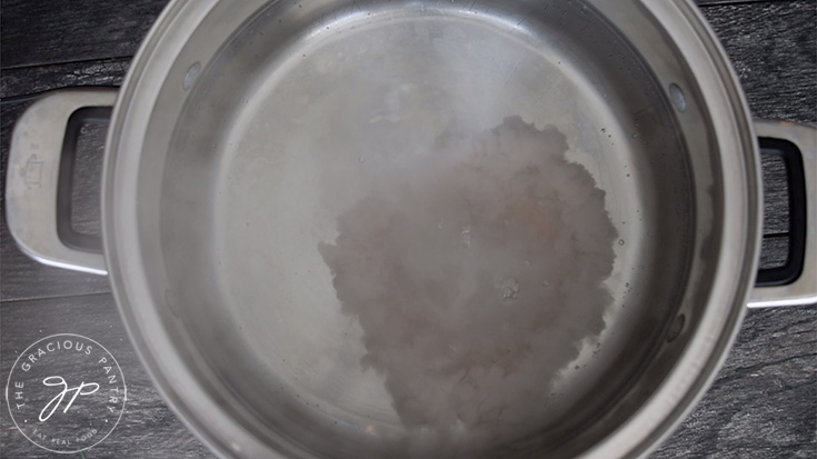 Salting the pasta water to make the pasta for this lasagna soup recipe.